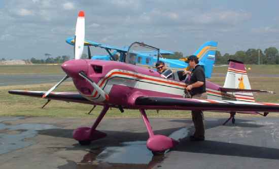 Steve buckling-up for aerobatics session in his CAP 232 assisted by son - Click to Enlarge